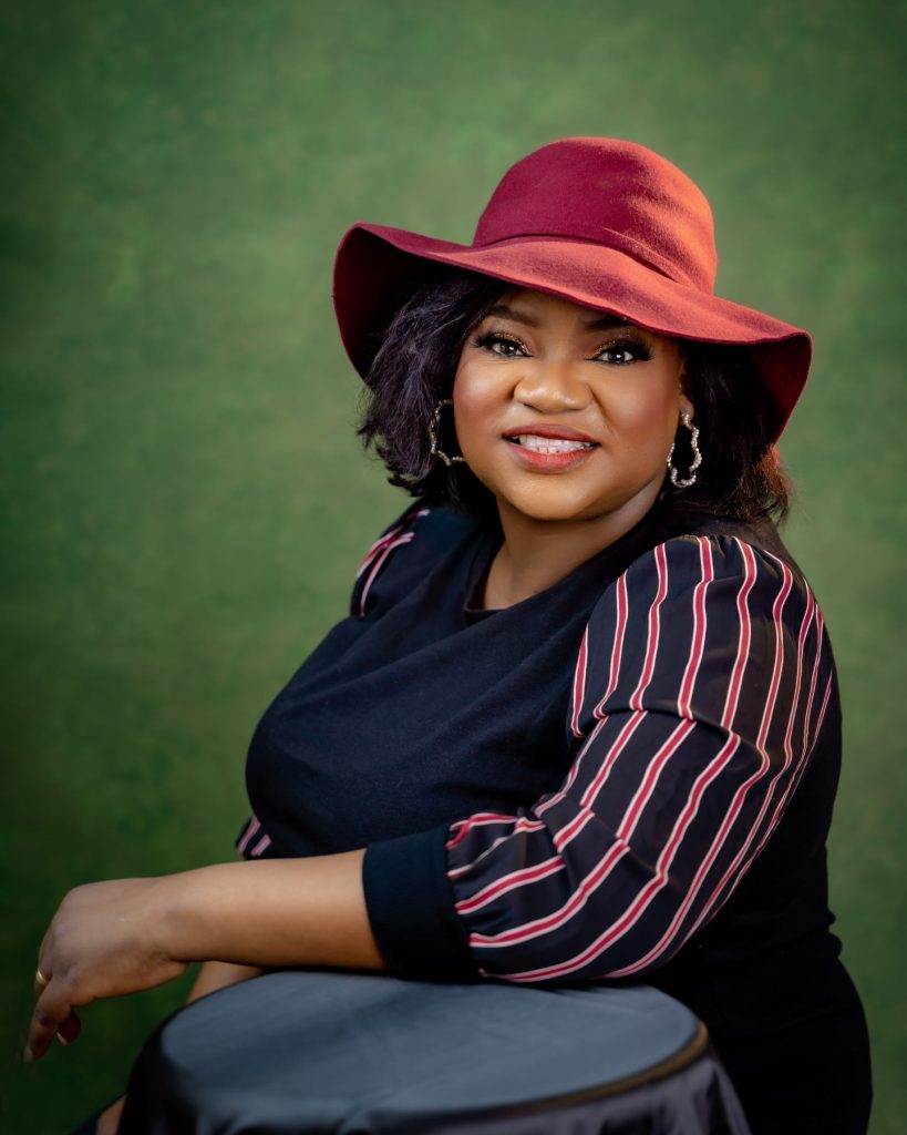 Ronke Taiwo wearing a red hat